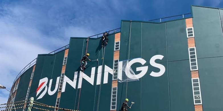 Up Down Access technicians on ropes working on a Bunnings store facade
